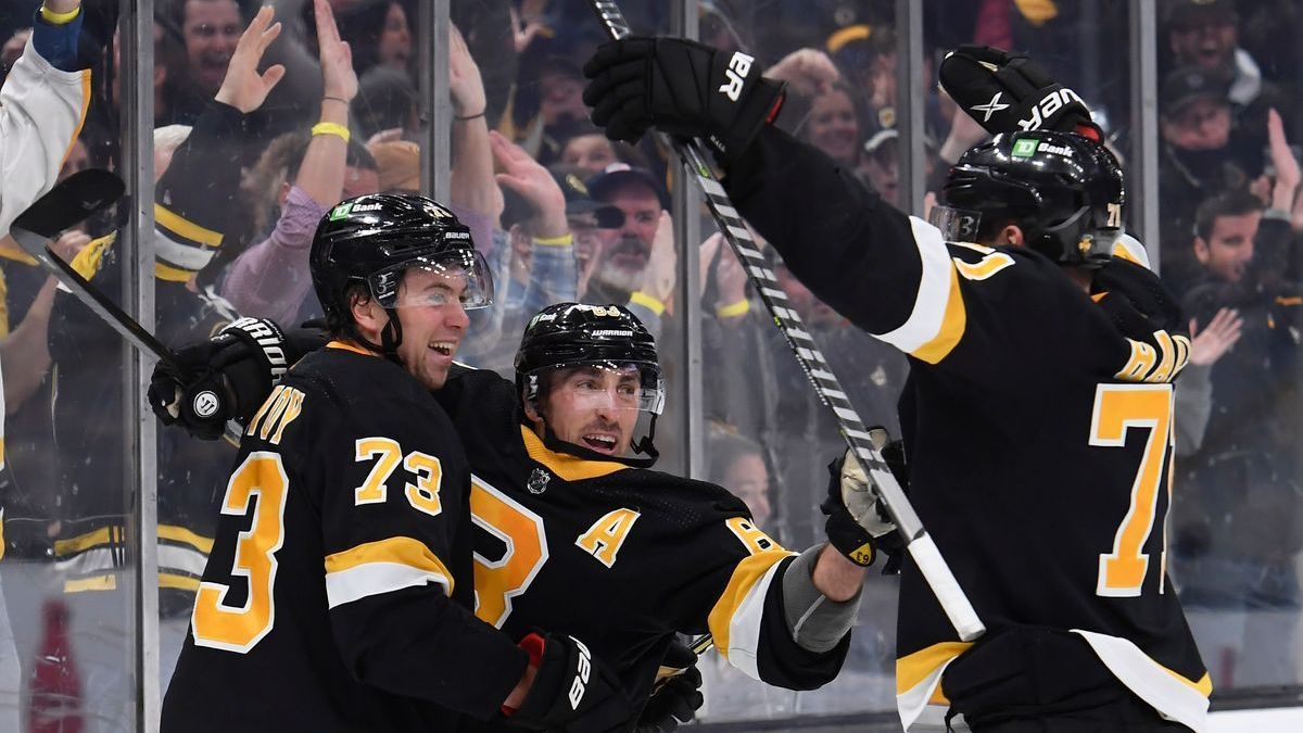 Boston Bruins' Charlie McAvoy, Brad Marchand, Taylor Hall