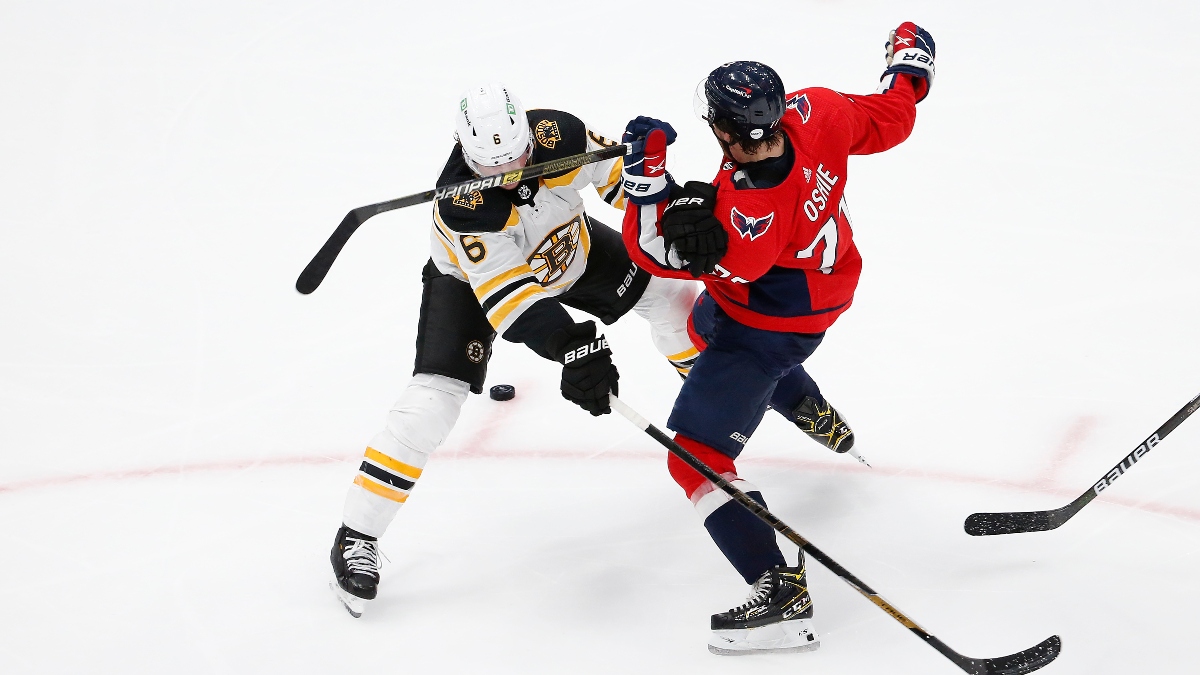 Washington Capitals right wing T.J. Oshie (77) and Boston Bruins defenseman Mike Reilly (6)