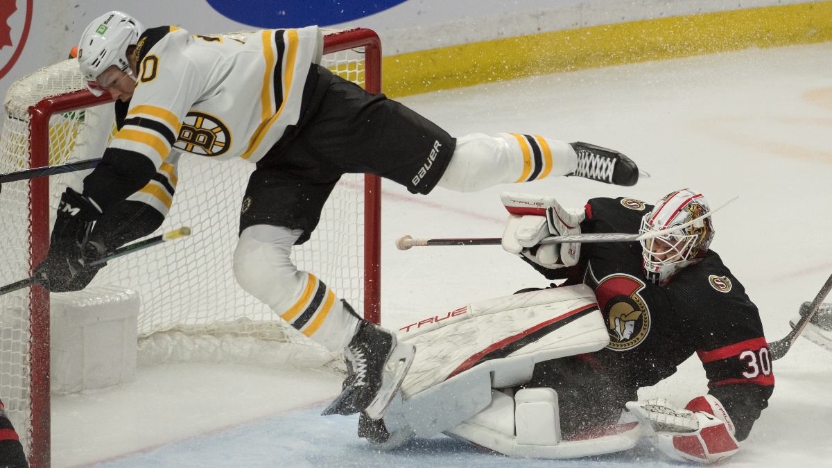 Boston Bruins center Curtis Lazar (20) and Ottawa Senators goalie Matt Murray (30)