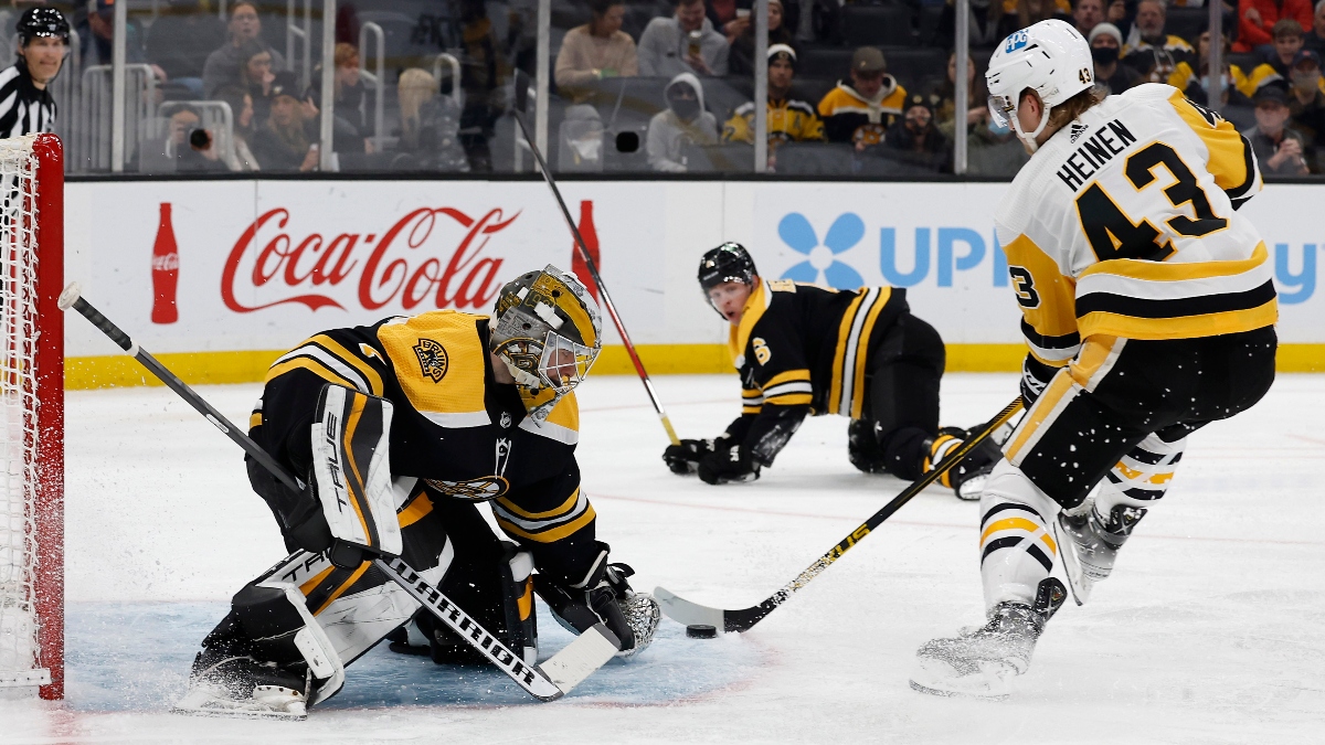 Pittsburgh Penguins left wing Danton Heinen (43) and Boston Bruins goaltender Jeremy Swayman (1)