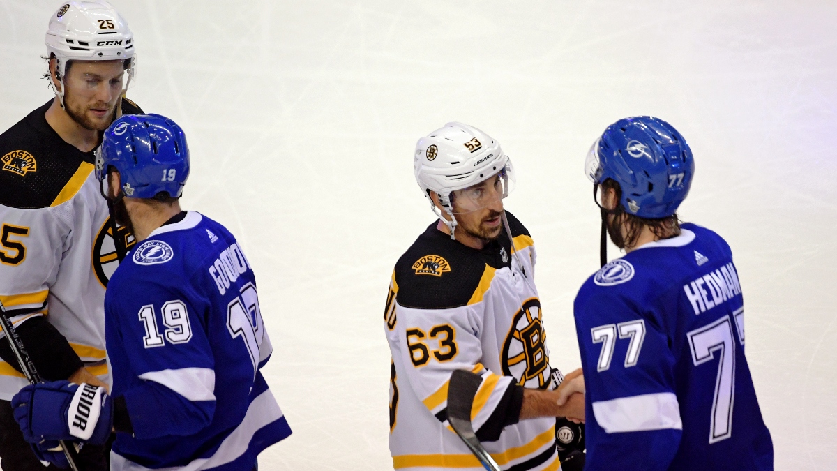 Boston Bruins defenseman Brandon Carlo (25) and left wing Brad Marchand (63) and Tampa Bay Lightning left wing Barclay Goodrow (19) and defenseman Victor Hedman (77)