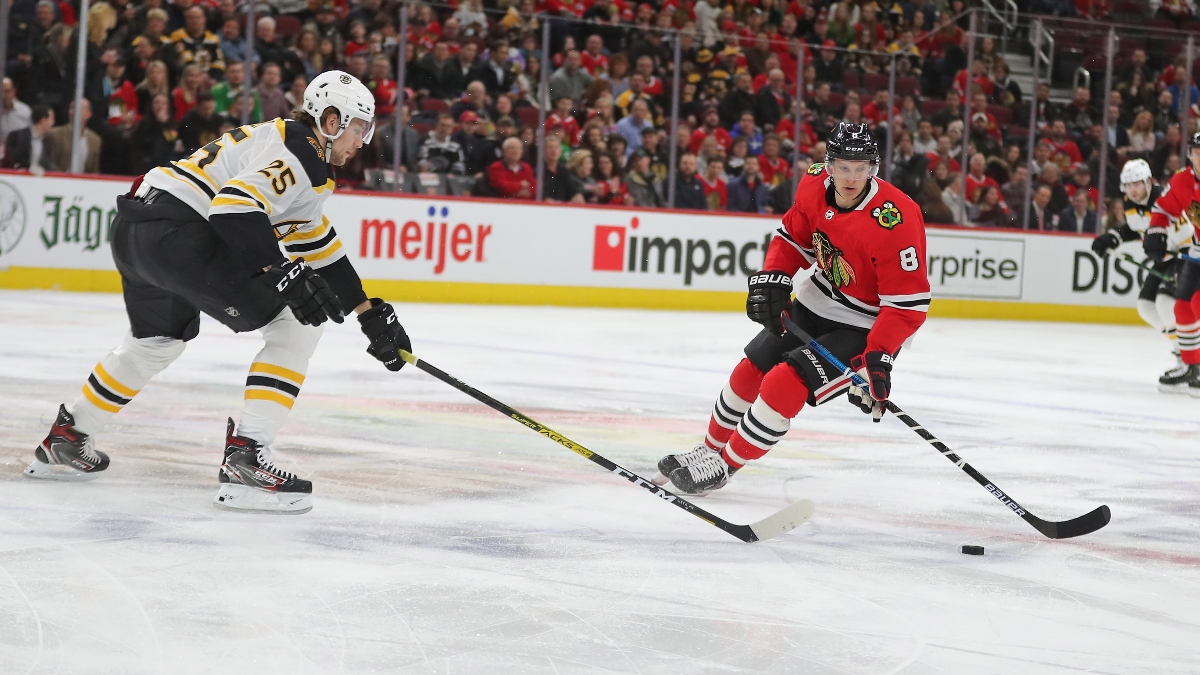 Chicago Blackhawks left wing Dominik Kubalik (8) and Boston Bruins defenseman Brandon Carlo (25)
