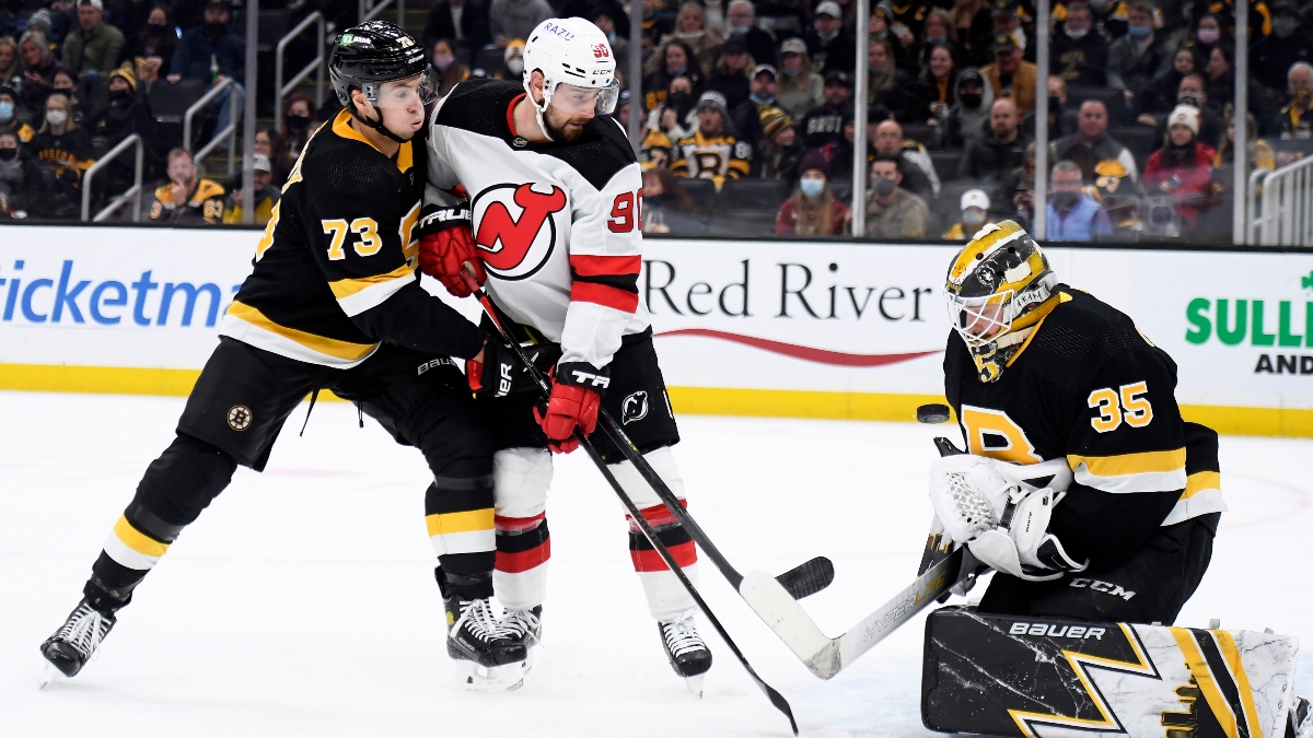 Boston Bruins goaltender Linus Ullmark (35) and defenseman Charlie McAvoy (73) and New Jersey Devils left wing Tomas Tatar (90)