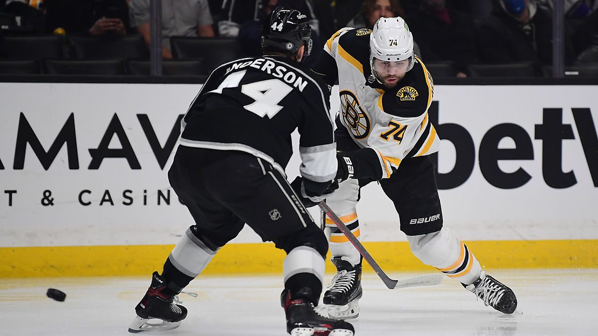 Los Angeles Kings defenseman Mikey Anderson and Boston Bruins right wing Jake DeBrusk