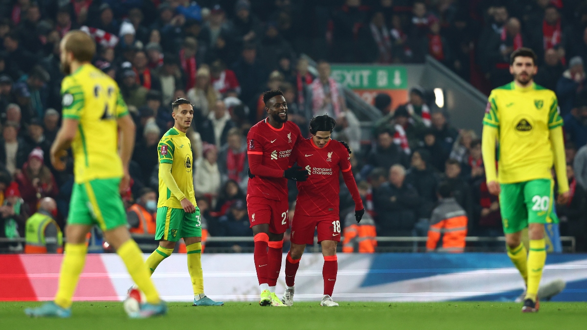 Liverpool forwards Divock Origi (27) and Takumi Minamino (18) and Norwich City players