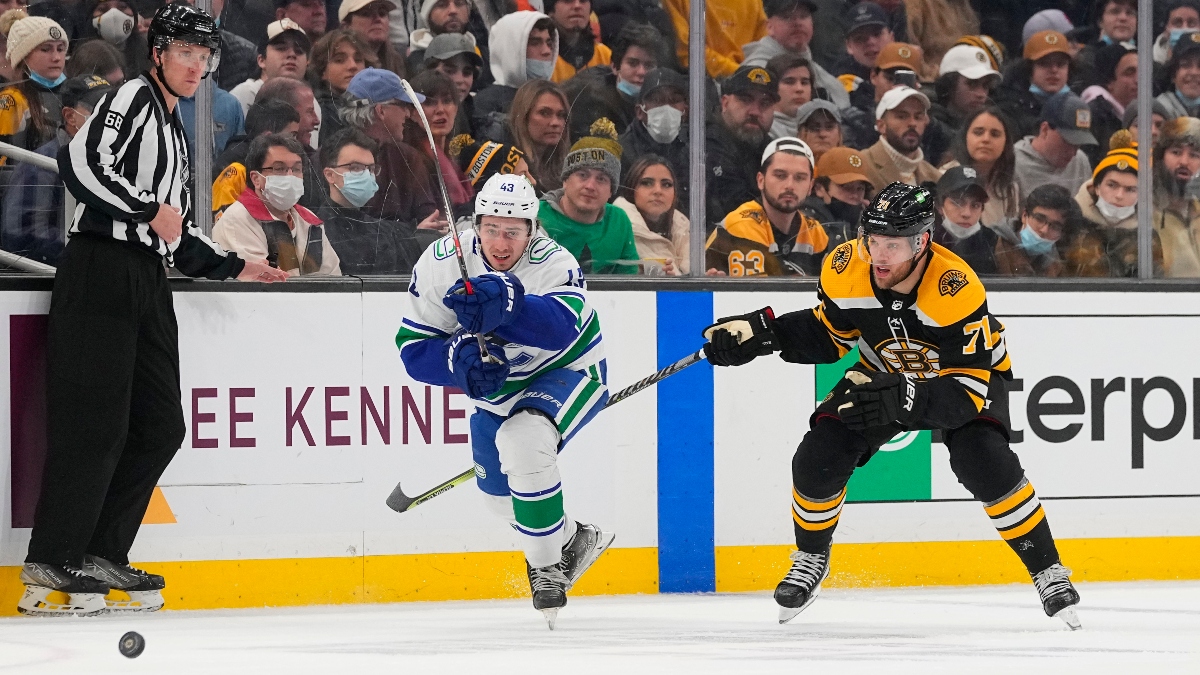 Vancouver Canucks defenseman Quinn Hughes (43) and Boston Bruins left wing Taylor Hall (71)