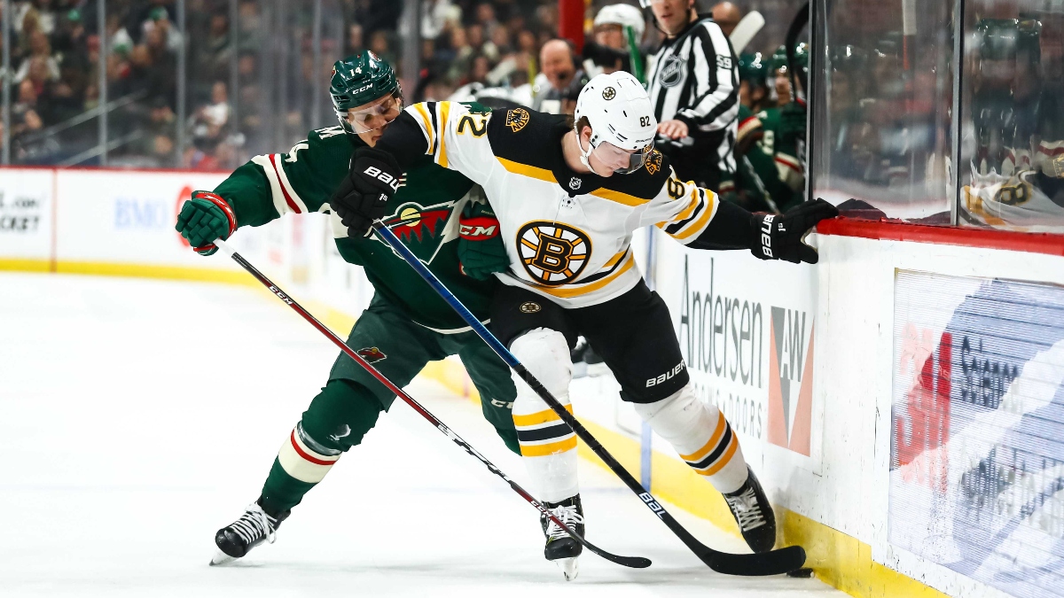 Boston Bruins left wing Trent Frederic (82) and Minnesota Wild center Joel Eriksson Ek (14)