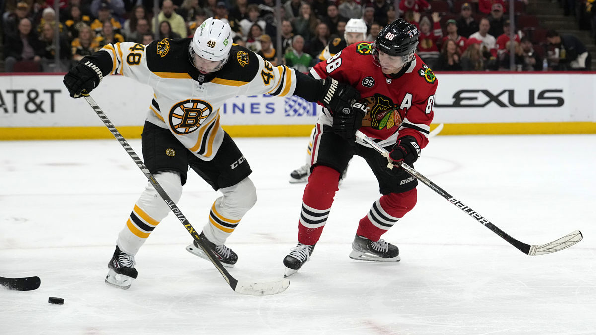 Boston Bruins defenseman Matt Grzelcyk, Chicago Blackhawks right wing Patrick Kane