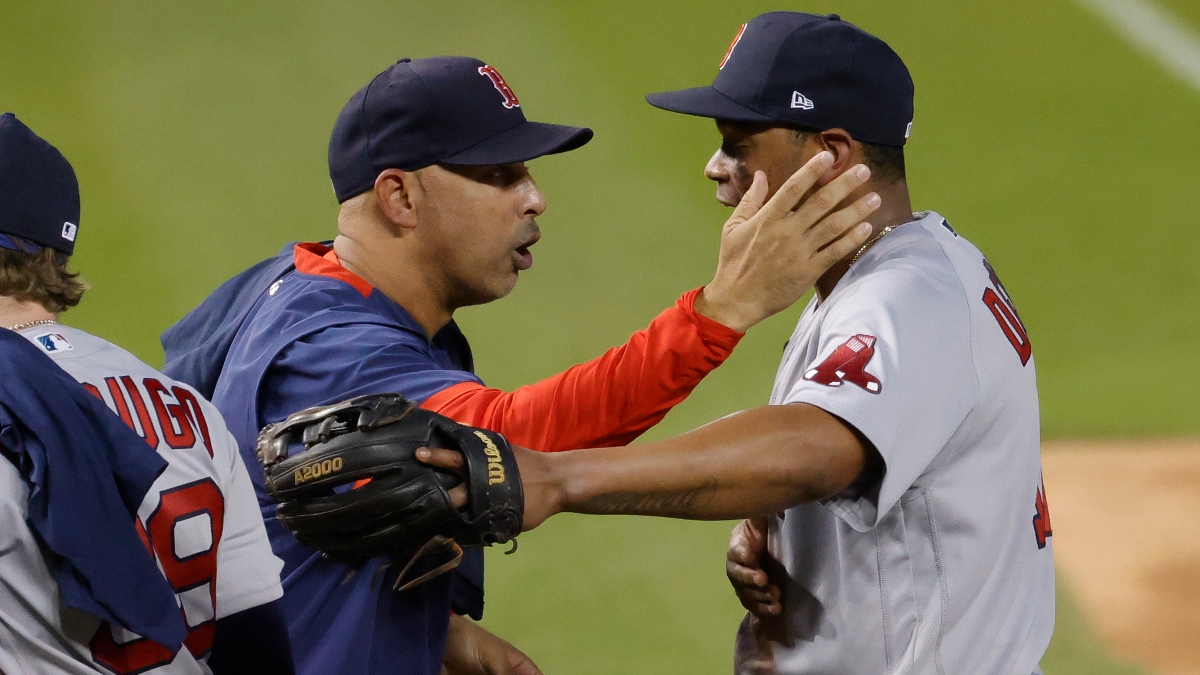 Boston Red Sox manager Alex Cora (L) and third baseman Rafael Devers (11)