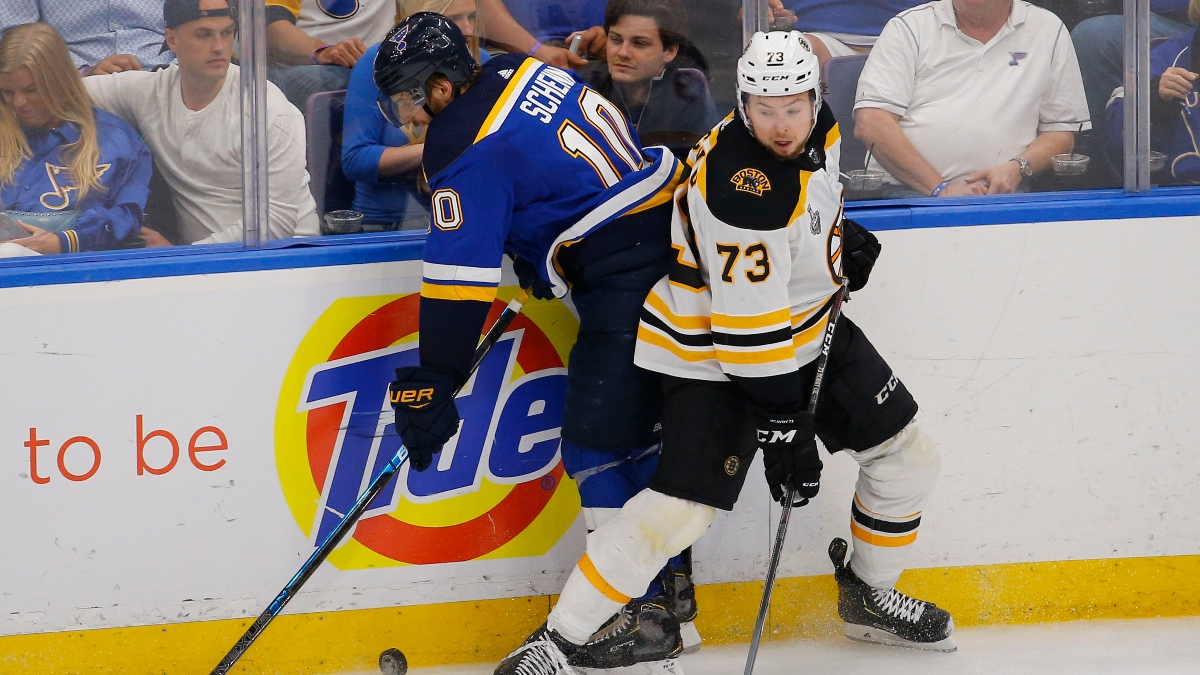 Boston Bruins defenseman Charlie McAvoy (73) and St. Louis Blues center Brayden Schenn (10)