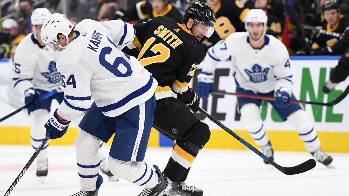Boston Bruins forward Craig Smith (12) and Toronto Maple Leafs forward David Kampf (64)