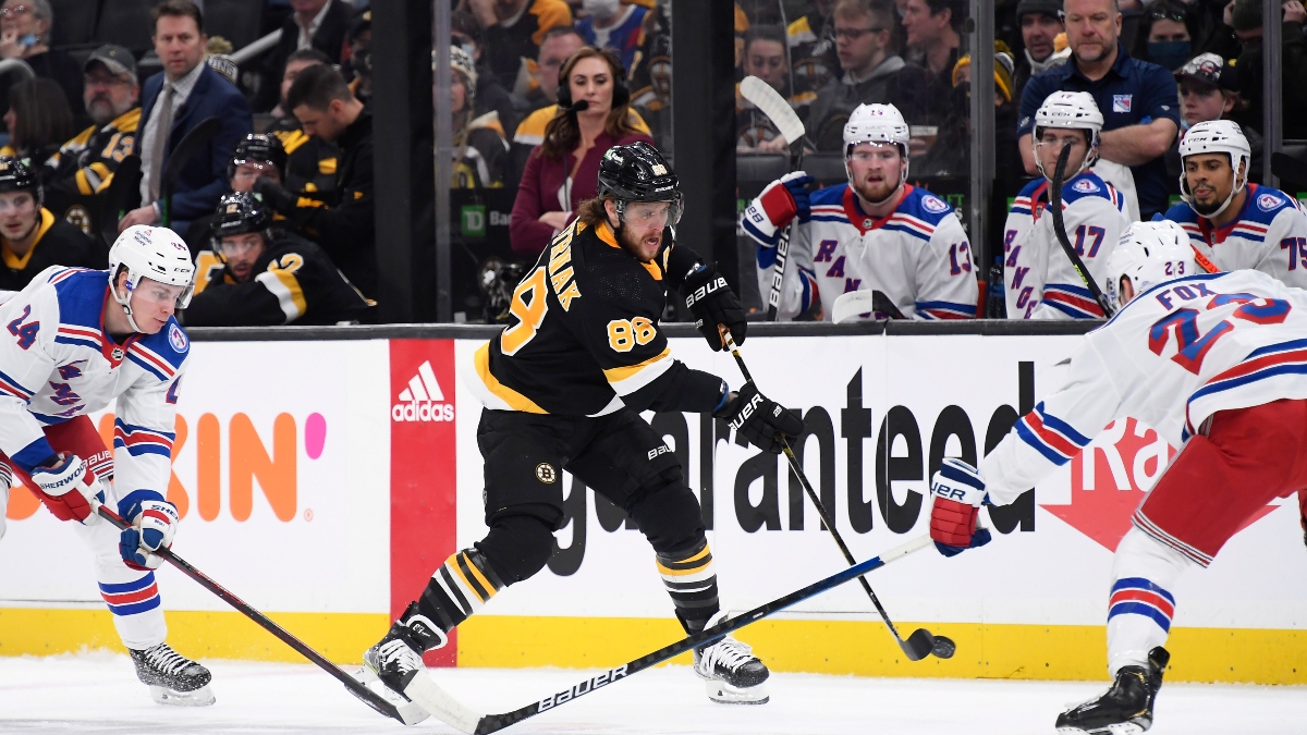 Boston Bruins right wing David Pastrnak (88) and New York Rangers defenseman Adam Fox (23)