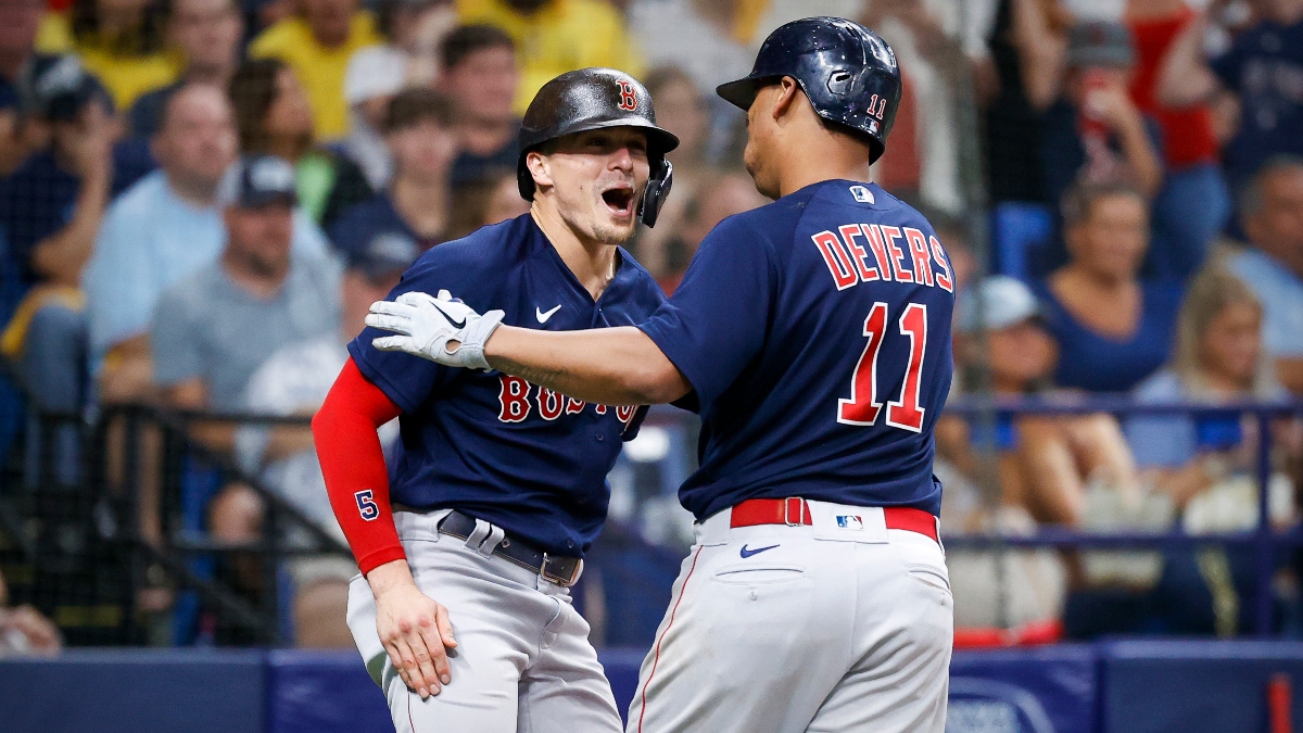 Boston Red Sox third baseman Rafael Devers (11) and center fielder Kiké Hernández (5) celebrate Devers' home run against the Tampa Bay Rays