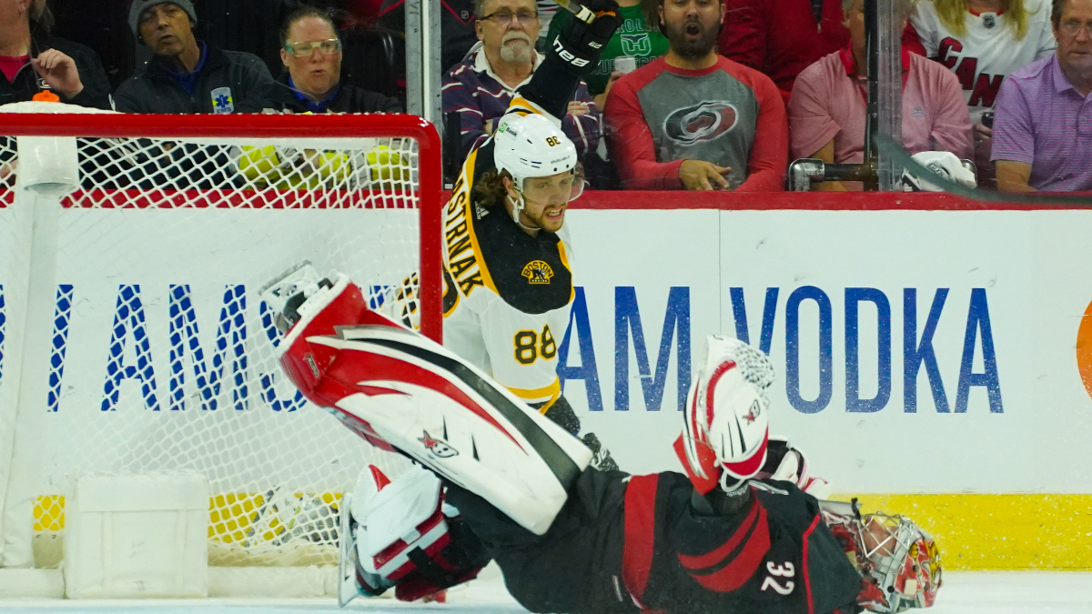 Boston Bruins right wing David Pastrnak and Carolina Hurricanes goalie Antti Raanta