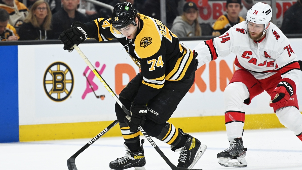 Boston Bruins right wing Jake DeBrusk (74) and Carolina Hurricanes defenseman Jaccob Slavin (74)