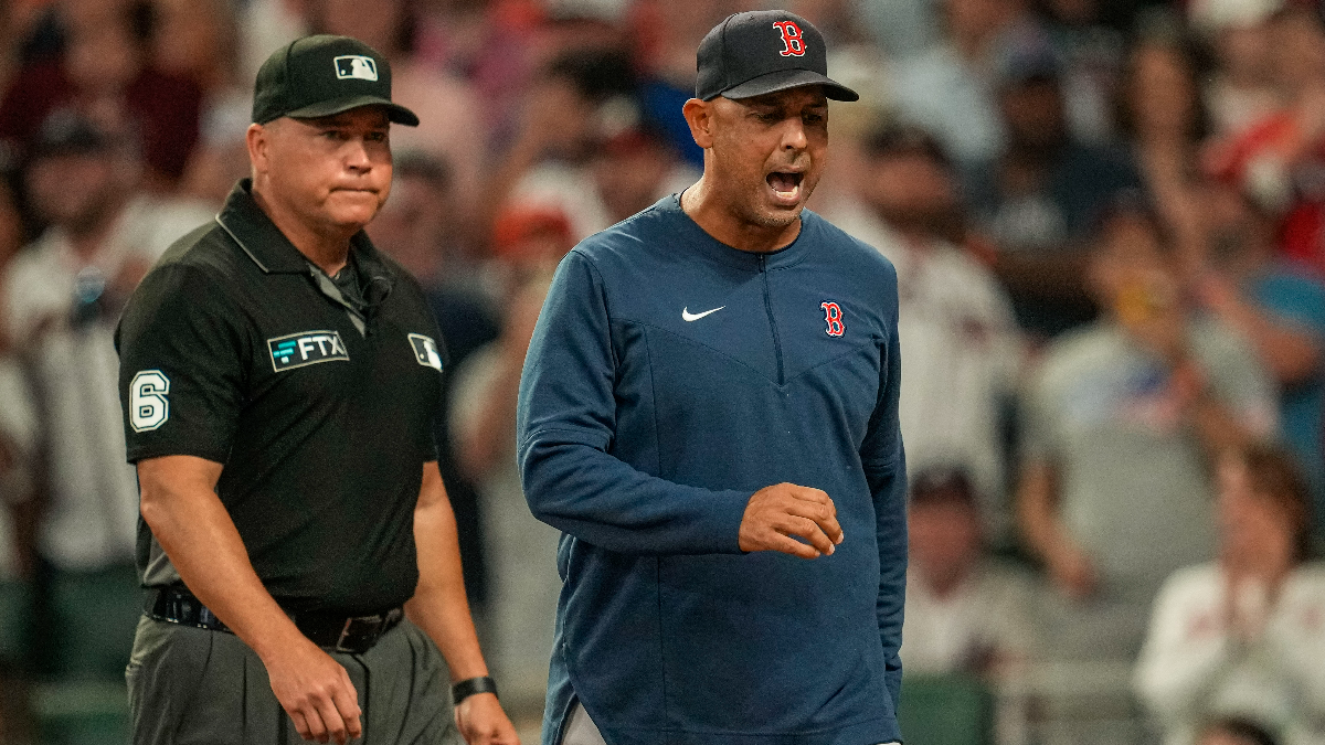 Major League Baseball umpire Mark Carlson and Boston Red Sox manager Alex Cora