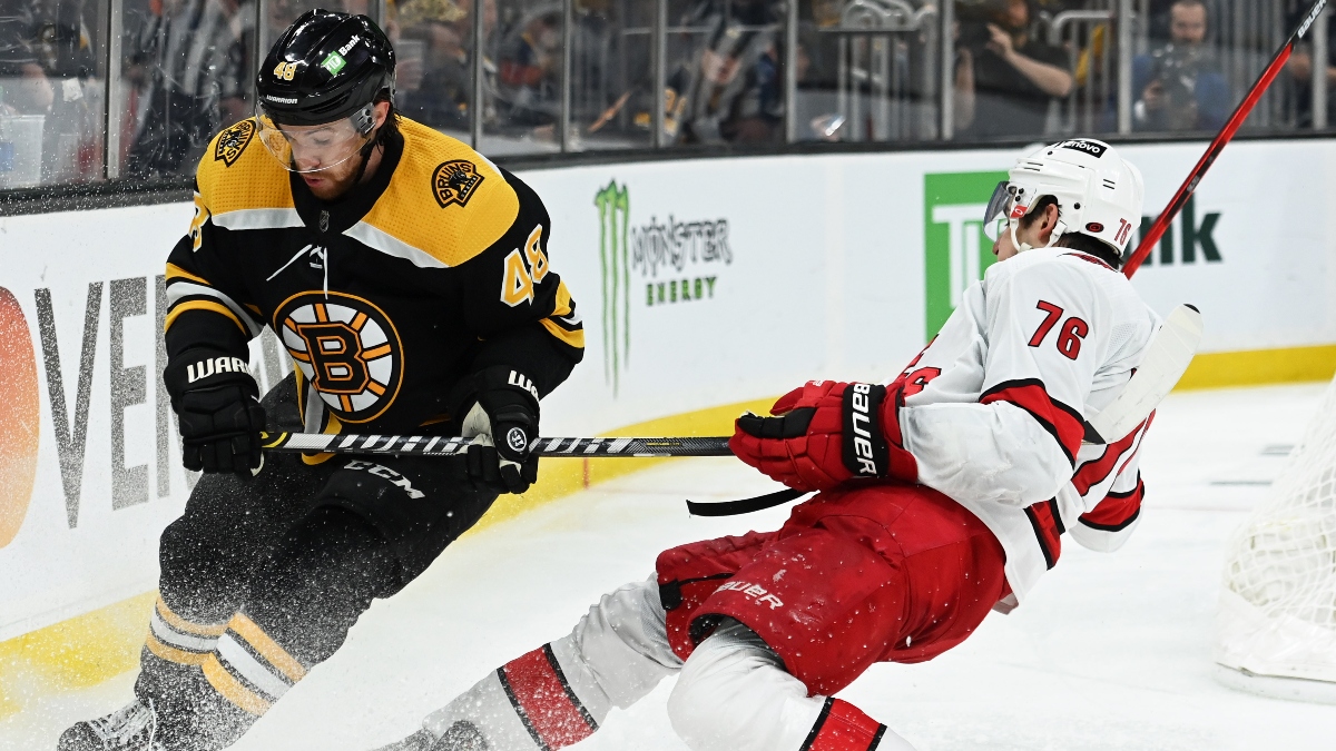 Boston Bruins defenseman Matt Grzelcyk (48) and Carolina Hurricanes defenseman Brady Skjei (76)
