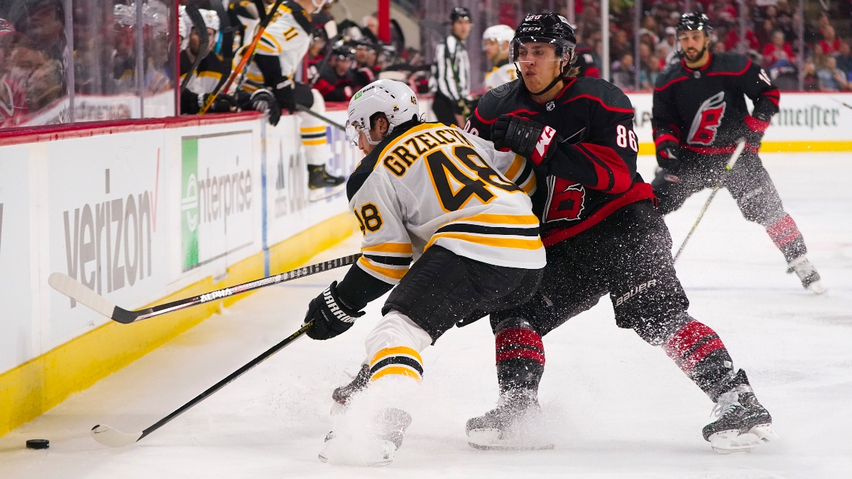 Carolina Hurricanes left wing Teuvo Teravainen (86) and Boston Bruins defenseman Matt Grzelcyk (48)