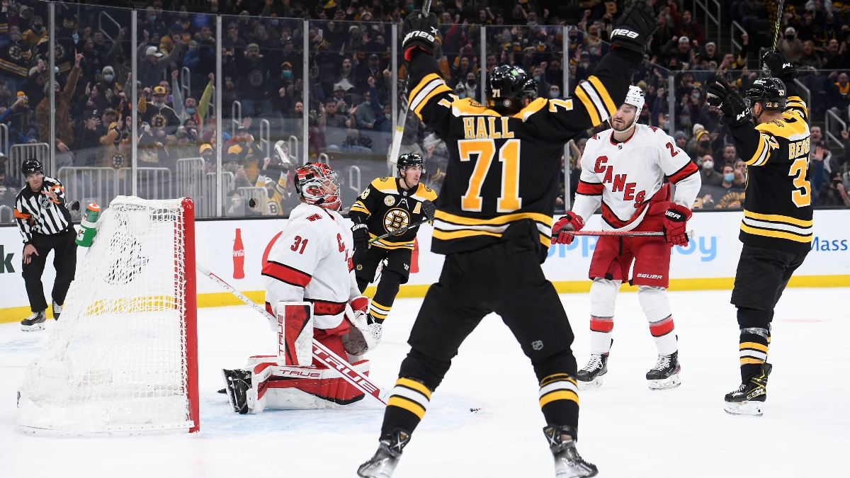 Boston Bruins center Patrice Bergeron (37), left wing Taylor Hall (71) and Carolina Hurricanes goaltender Frederik Andersen (31)