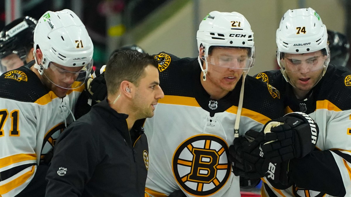Boston Bruins defenseman Hampus Lindholm (27), left wing Jake DeBrusk (74), left wing Taylor Hall (71)
