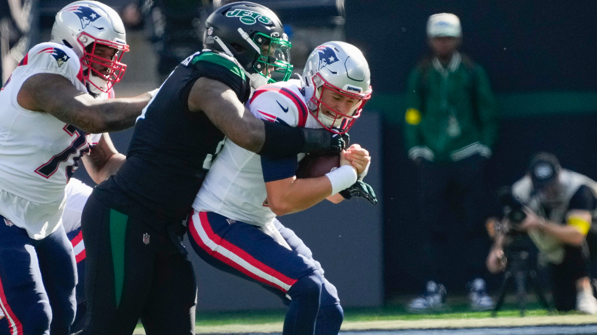 New York Jets defensive end John Franklin-Myers and New England Patriots quarterback Mac Jones