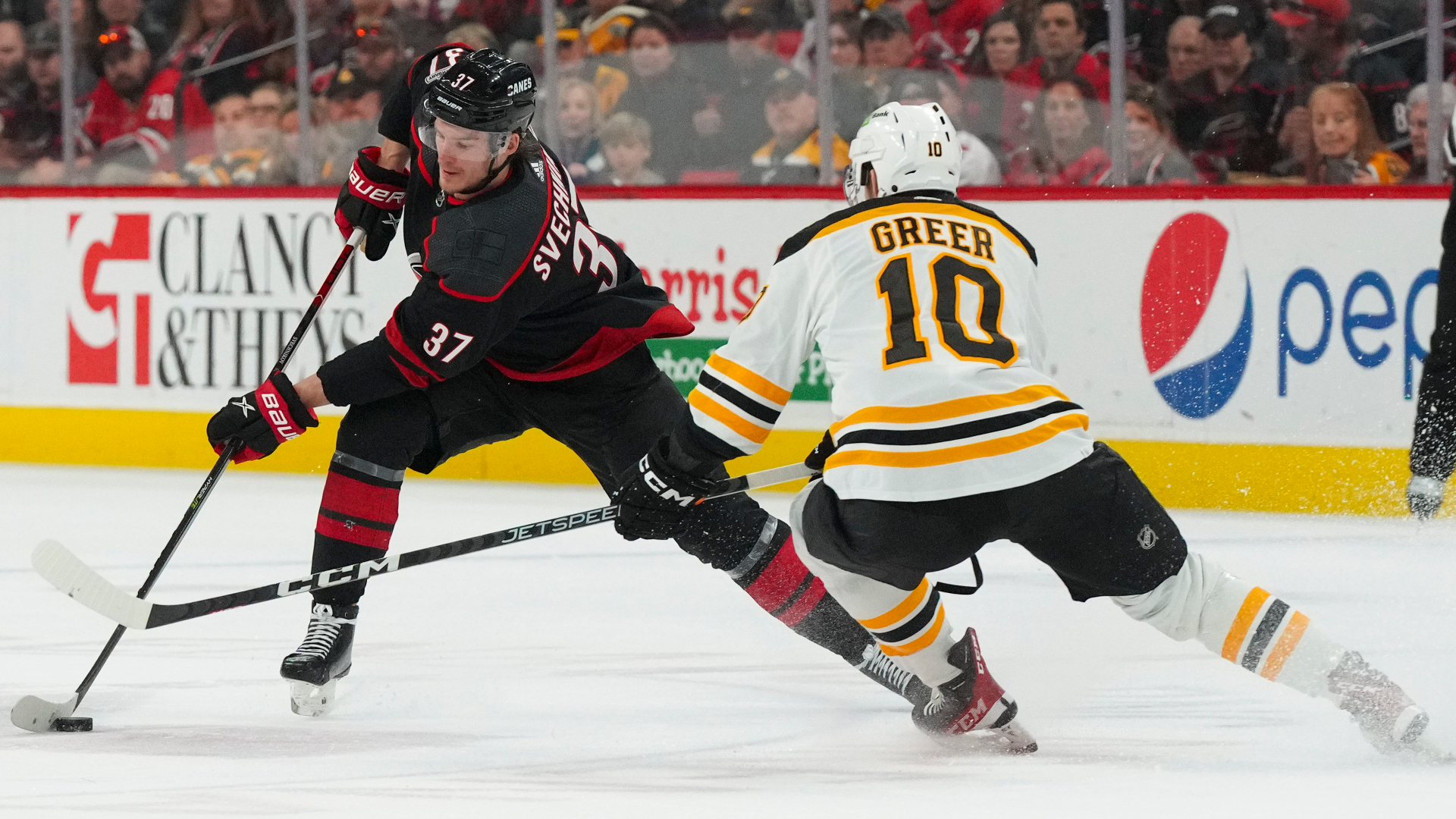 Carolina Hurricanes forward Andrei Svechnikov and Boston Bruins forward A.J. Greer
