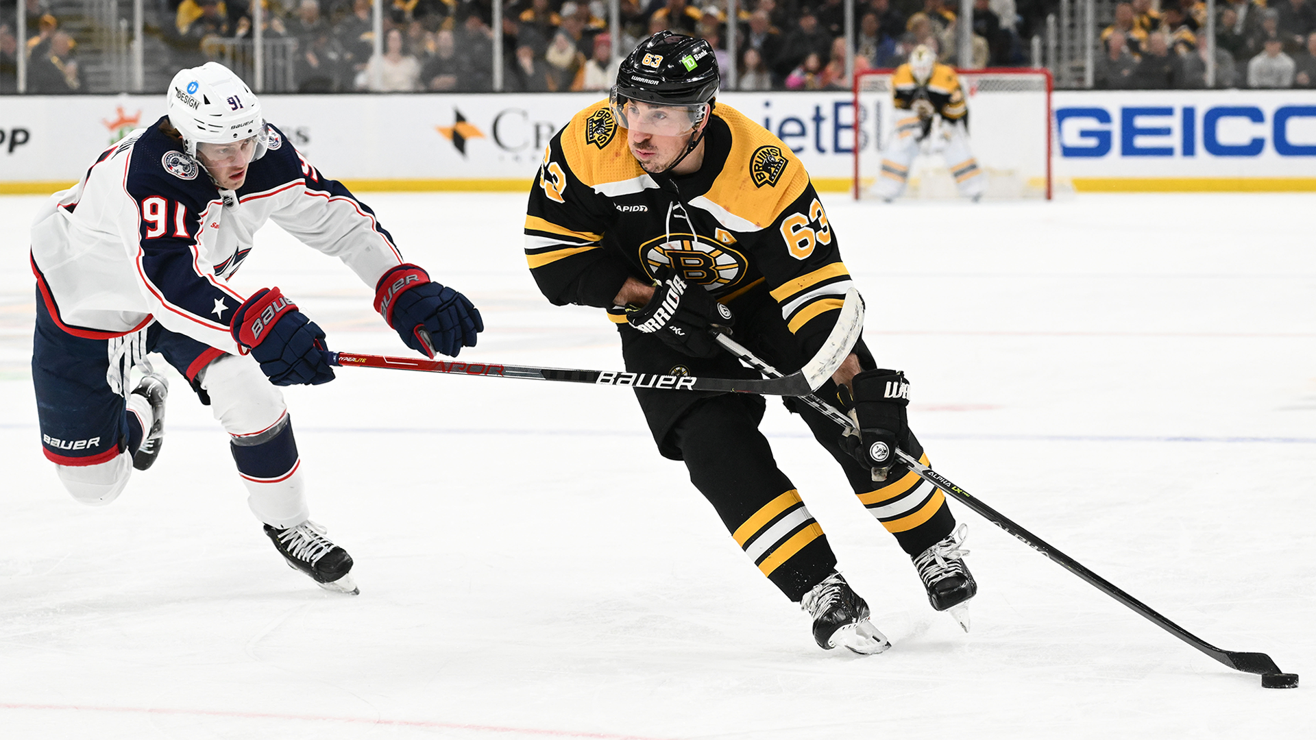 Boston Bruins forward Brad marchand and Columbus Blue Jackets forward Kent Johnson