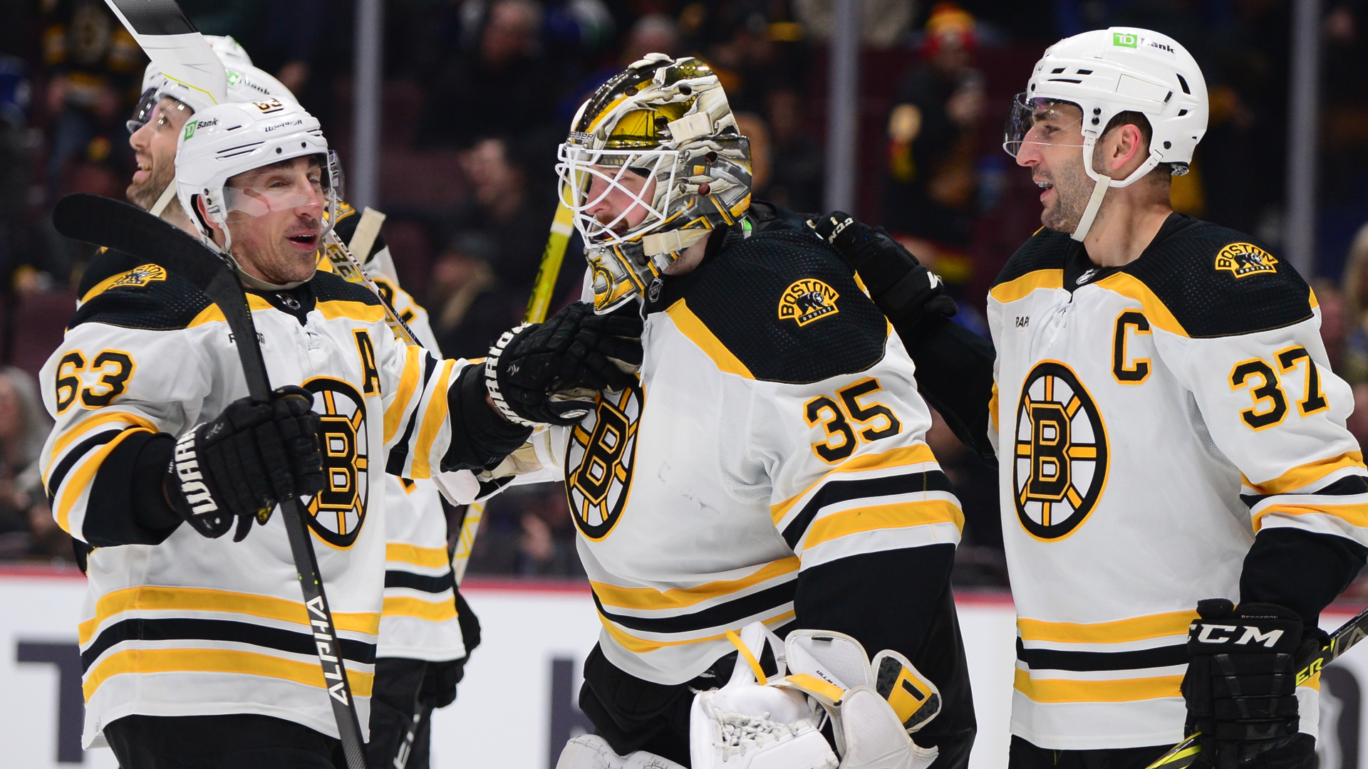 Boston Bruins forward Brad Marchand, goaltender Linus Ullmark and forward Patrice Bergeron