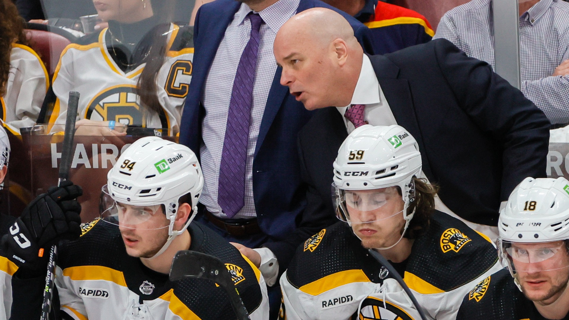 Boston Bruins head coach Jim Montgomery, forward Jakub Lauko