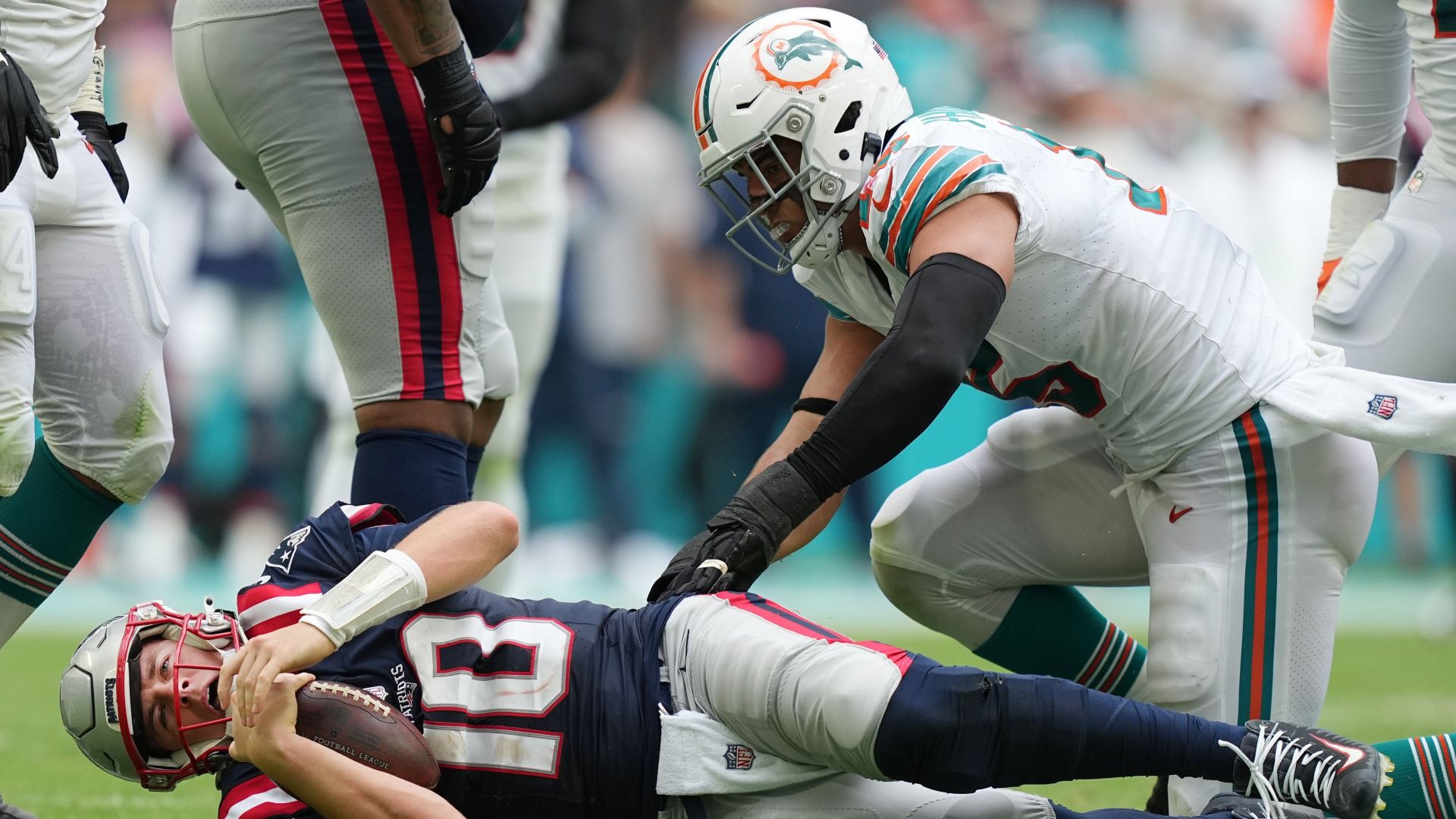 New England Patriots quarterback Mac Jones and Miami Dolphins linebacker Jalean Phillips