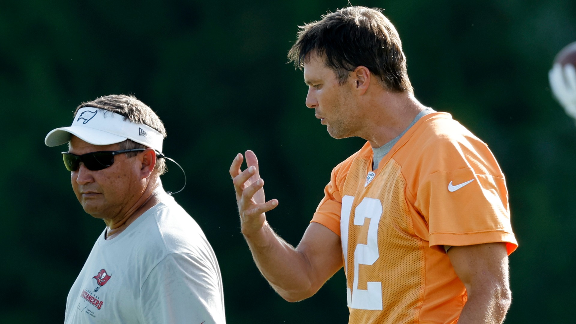 North Carolina Tar Heels advisor Clyde Christensen, former Tampa Bay Buccaneers quarterback Tom Brady