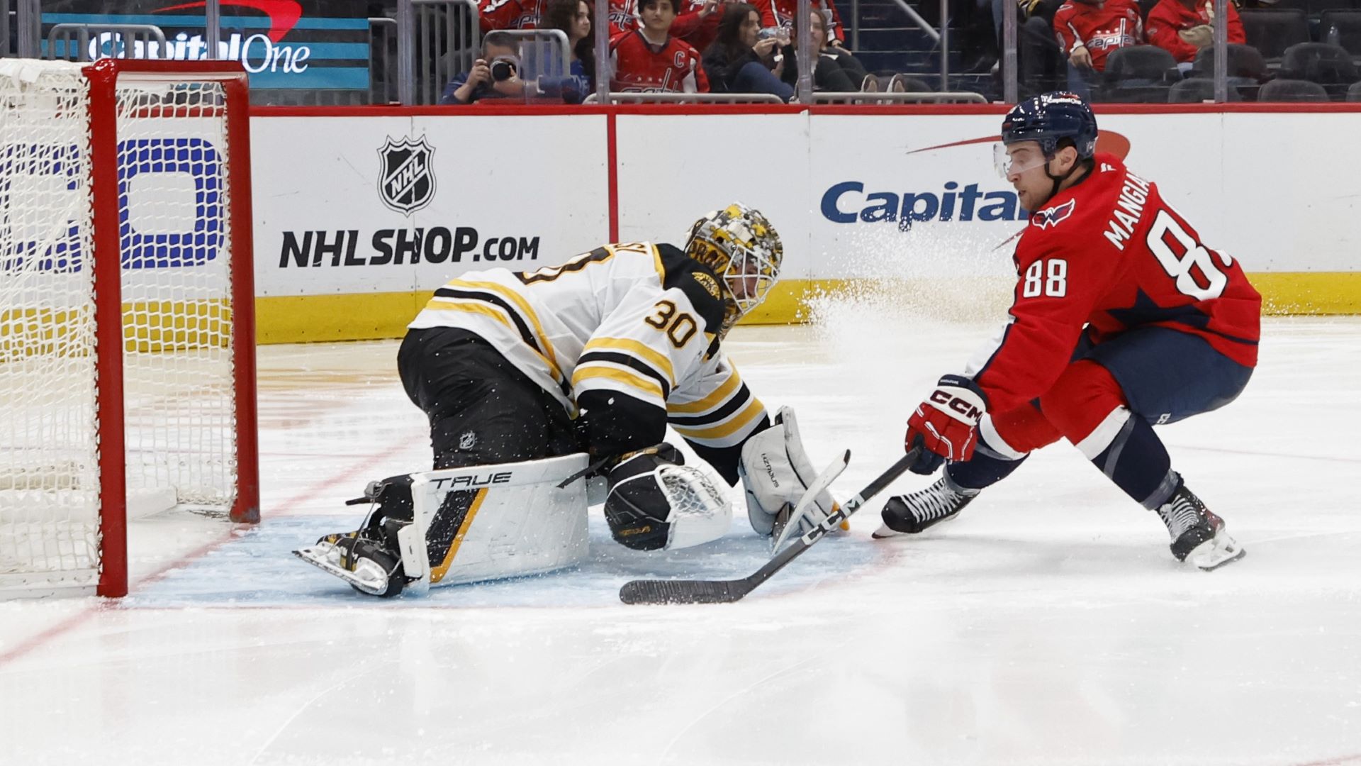 Boston Bruins goalie Brandon Bussi and Washington Capitals forward Andrew Mangiapane