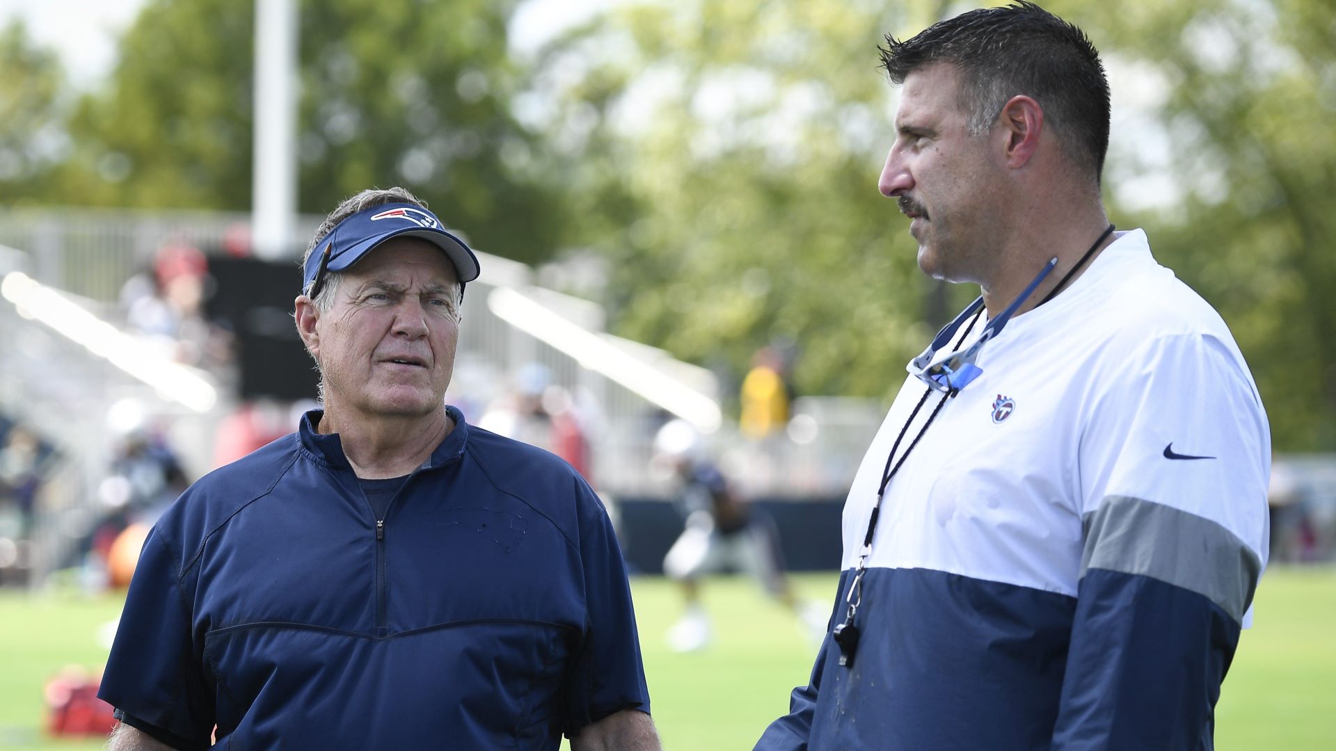 New England Patriots head coach Mike Vrabel and North Carolina head coach Bill Belichick