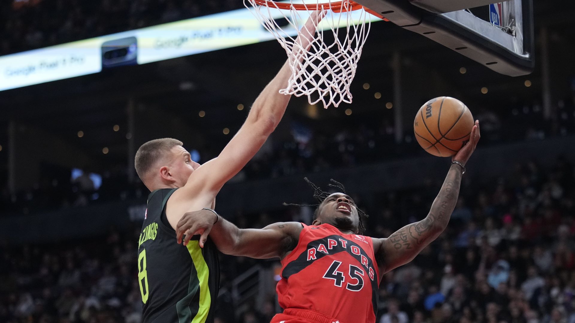 Boston Celtics center Kristaps Porzingis and Toronto Raptors guard Davion Mitchell