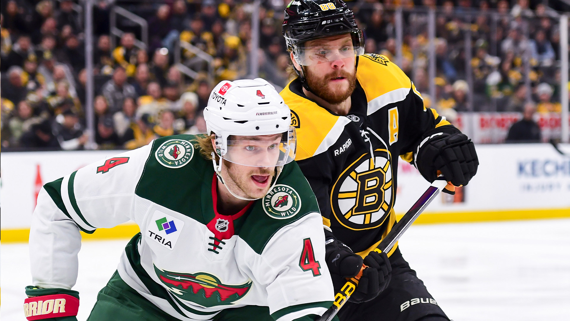 Minnesota Wild defenseman Jon Merrill and Boston Bruins forward David Pastrnak.