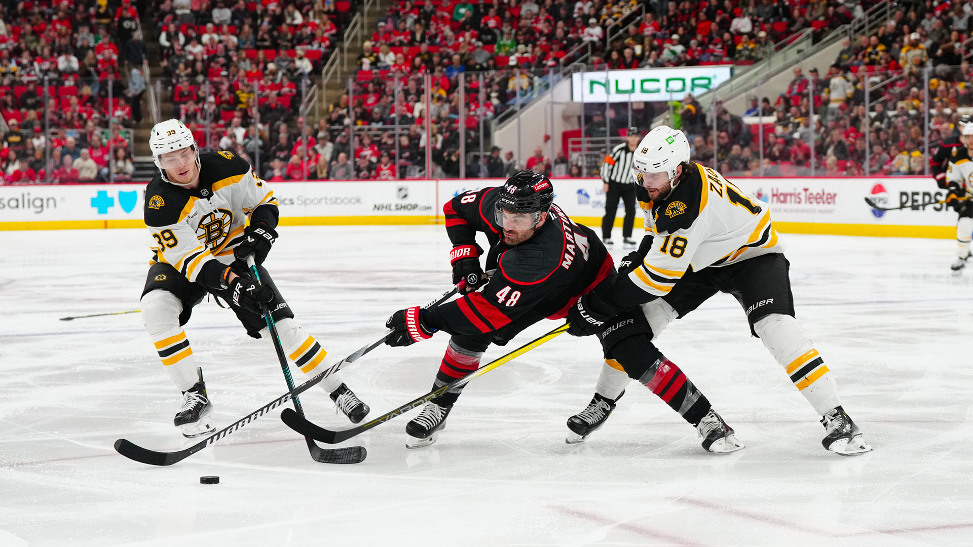 Boston Bruins center Pavel Zacha and center Morgan Geekie Carolina Hurricanes left wing Jordan Martinook