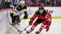 Boston Bruins defenseman Andrew Peeke and New Jersey Devils forward Paul Cotter