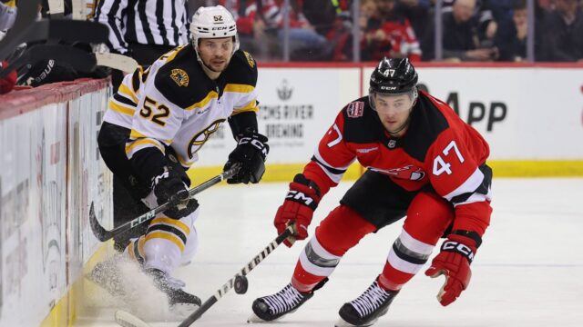 Boston Bruins defenseman Andrew Peeke and New Jersey Devils forward Paul Cotter