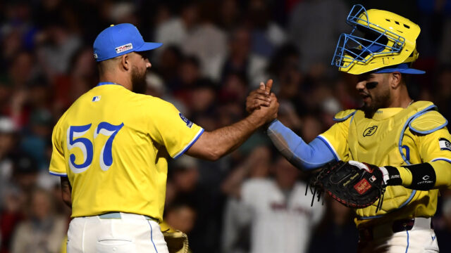 Boston Red Sox relief pitcher Greg Weissert (57) is congratulated by catcher Carlos Narvaez (75) after defeating the New York Yankees at Fenway Park.