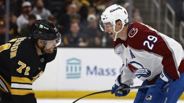 Boston Bruins left wing Viktor Arvidsson and Colorado Avalanche center Nathan MacKinnon
