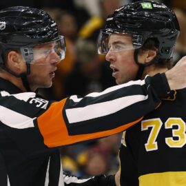 Referee Peter MacDougall and Boston Bruins defenseman Charlie McAvoy