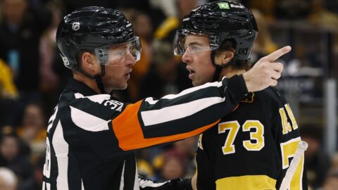 Referee Peter MacDougall and Boston Bruins defenseman Charlie McAvoy
