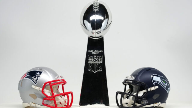 New England Patriots and Seattle Seahawks helmets with Super Bowl Vince Lombardi trophy